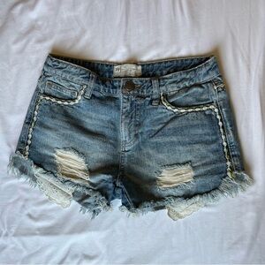 Free People high waisted distressed denim shorts with lace trim